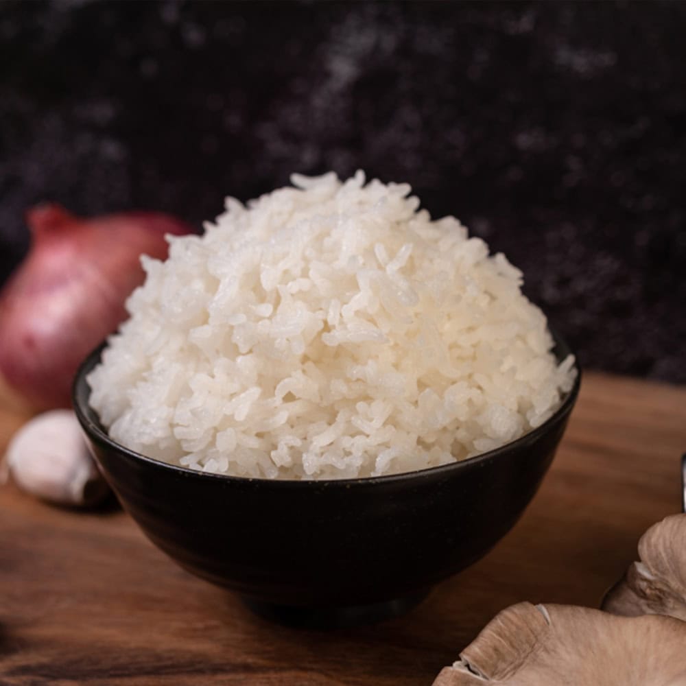 Fluffy cooked white rice in black bowl, traditional Indian cuisine ingredient, suitable for Windang diners.
