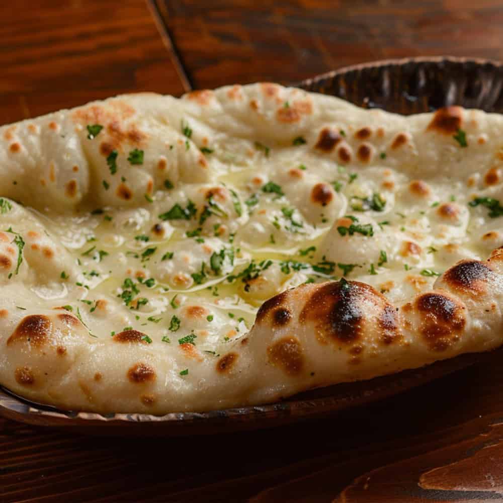 Creamy Garlic Naan Bread with Fresh Herbs at Crown Indian Windang.