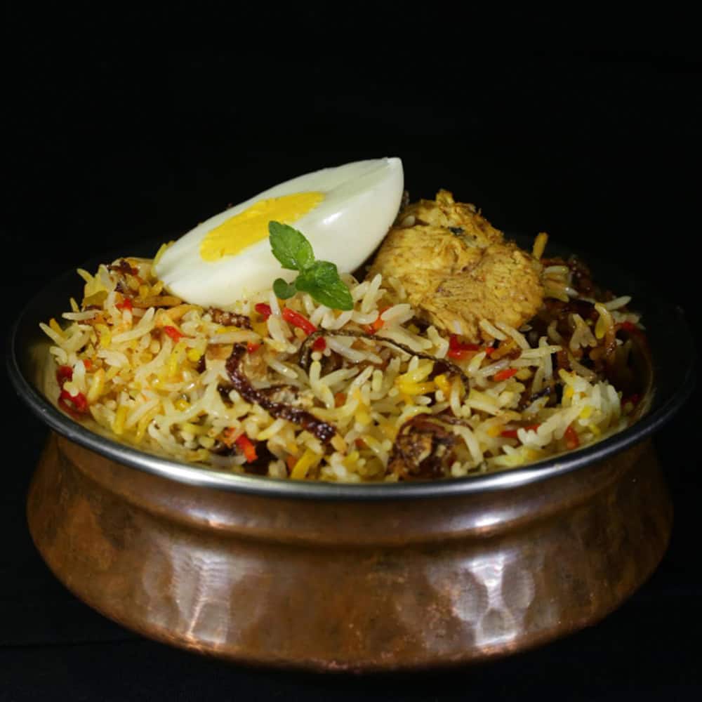Steamed biryani rice with boiled egg, chicken, spices, and herbs from Crown Indian Cuisine Windang.