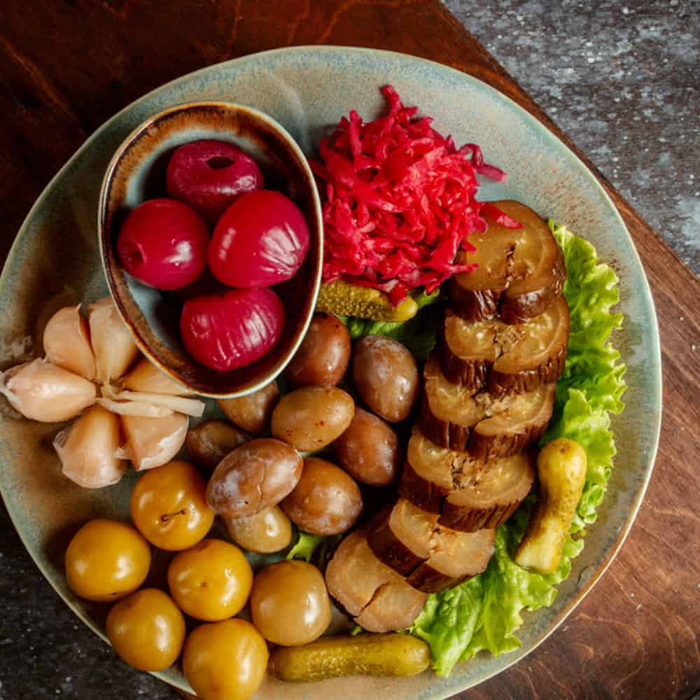 Colorful Indian pickles and vegetables platter at Crown Indian Cuisine Windang, authentic Indian restaurant.