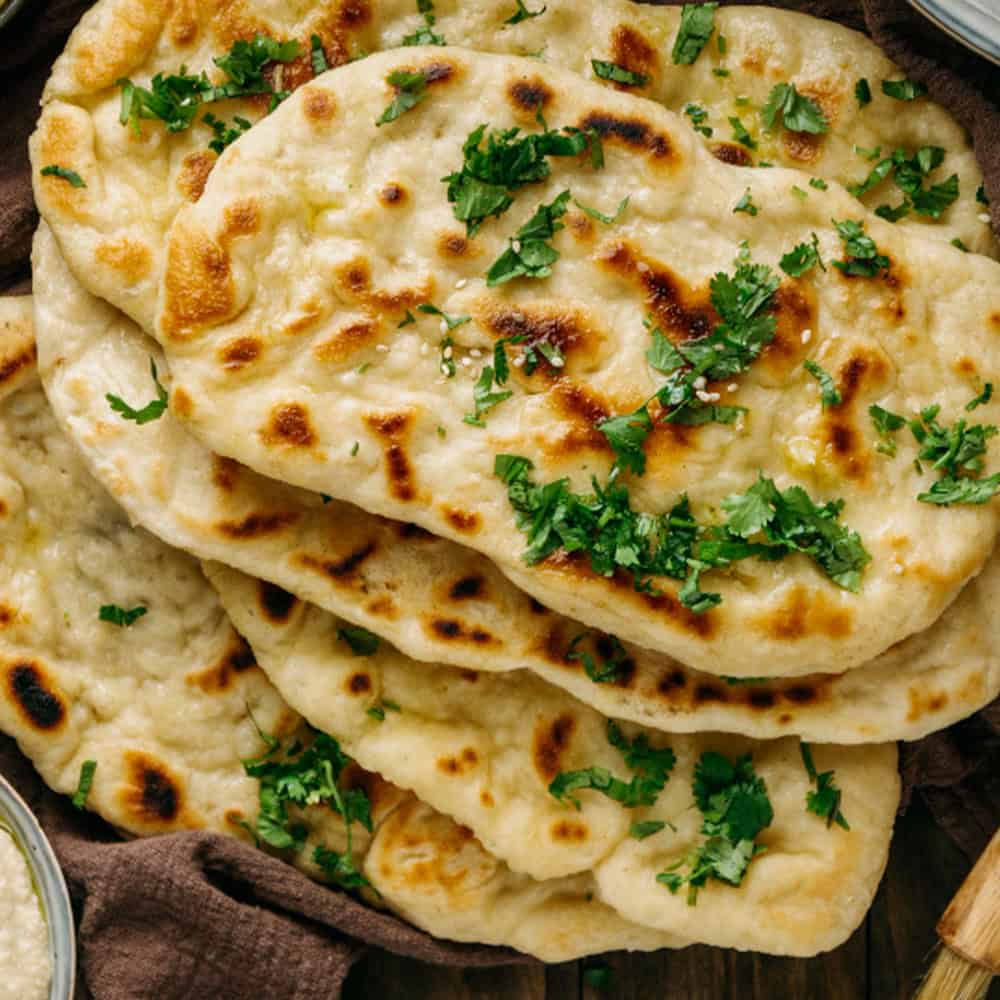 Fresh Indian naan bread with herbs from Crown Indian Cuisine Windang, perfect for authentic Indian dining.
