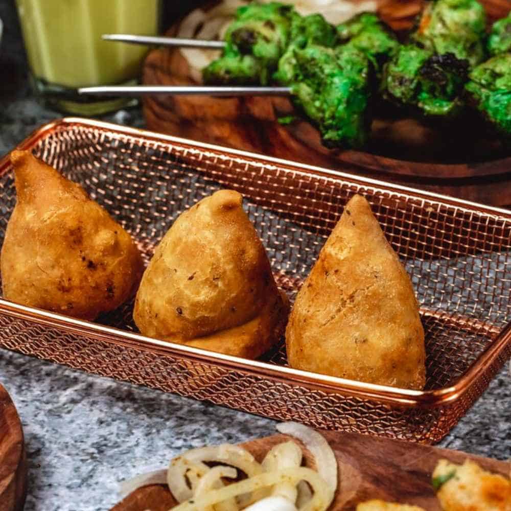 Golden fried samosas served with Indian spices and crispy exterior. Perfect appetizer at Crown Indian Cuisine Windang.