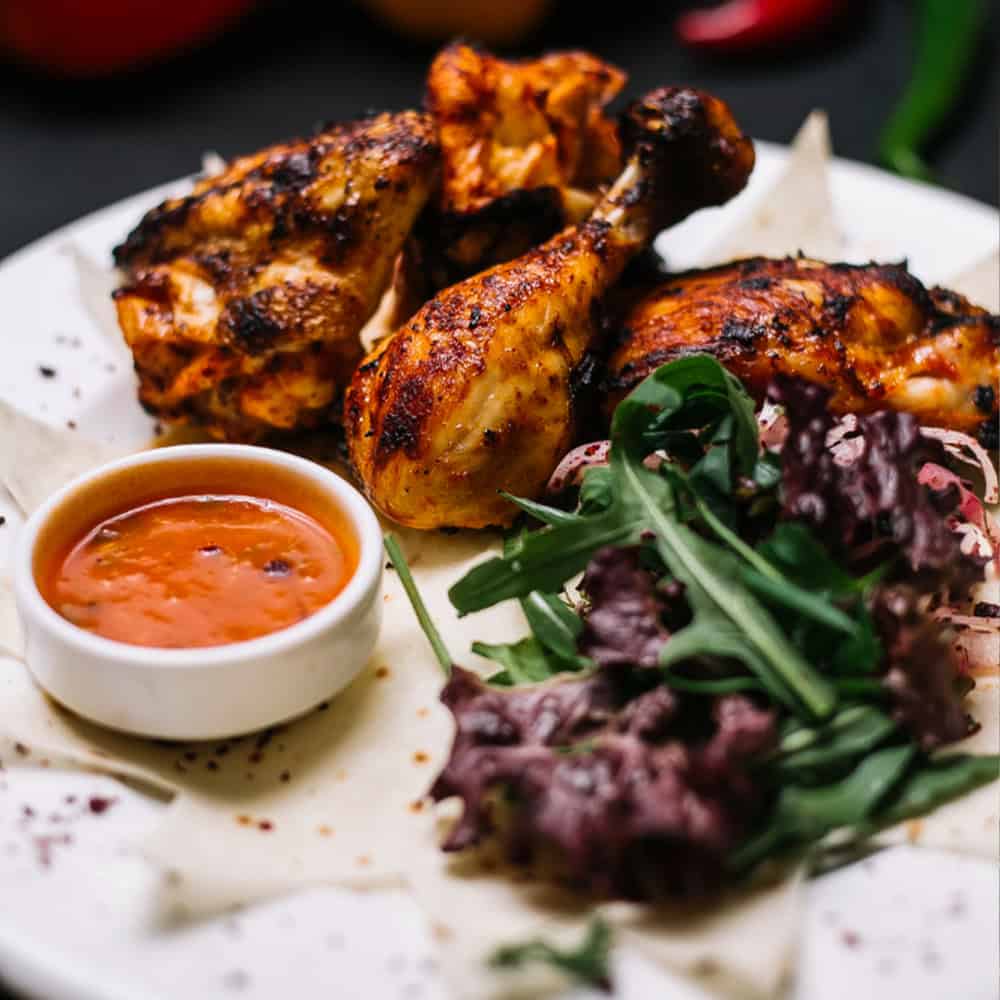 Crown Indian Cuisine Windang - Tasty grilled chicken with fresh salad and spicy dipping sauce.