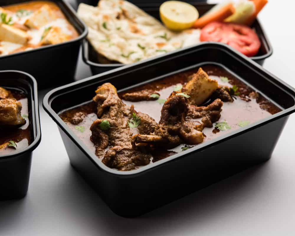 Steak curry served in a black food container, highlighting Indian cuisine favorites at Crown Indian Cuisine Windang.