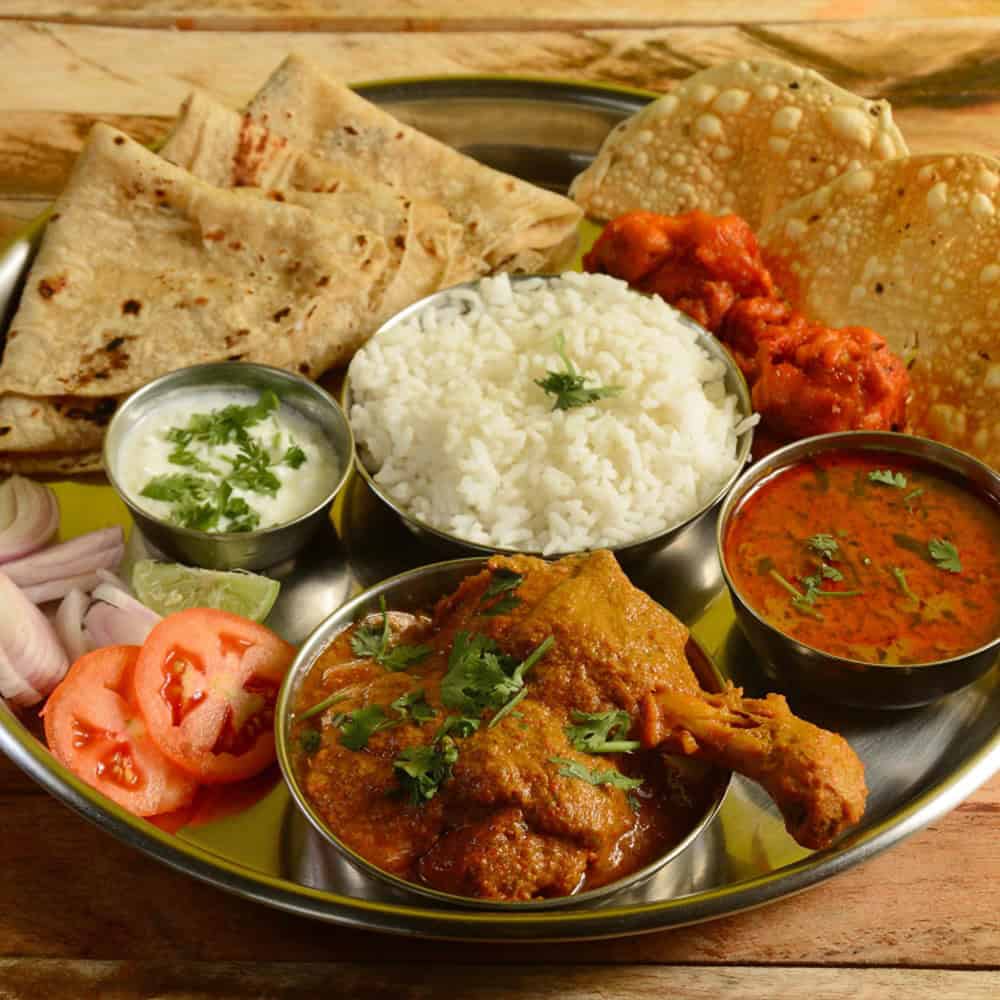 Delicious Indian cuisine platter with rice, naan, curry, and chutney at Crown Indian Windang.