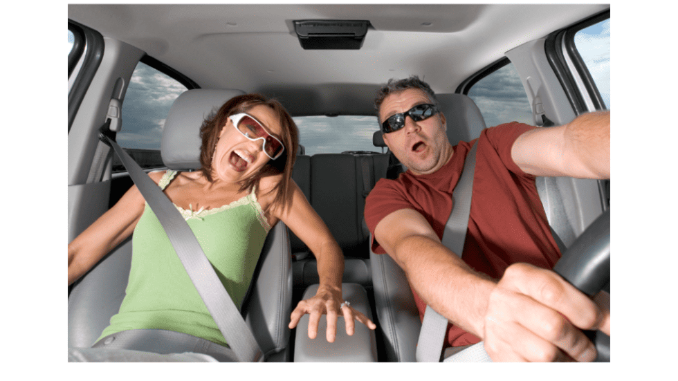 Happy couple enjoying a fun road trip in a car.