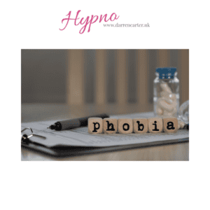 Scrabble tiles spelling 'phobia' on a desk with a notepad and pen.