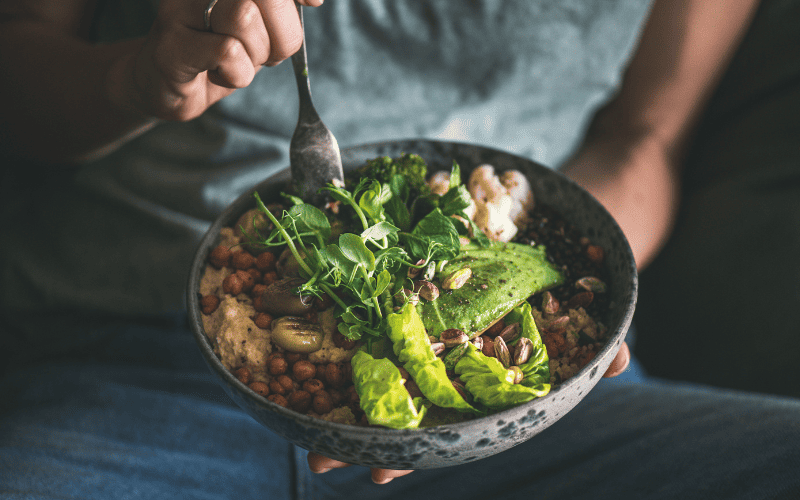 Fresh healthy salad with greens, avocado, and nuts for wellness.
