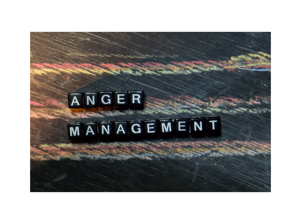 Scrabble tiles spelling anger management on dark wooden background.