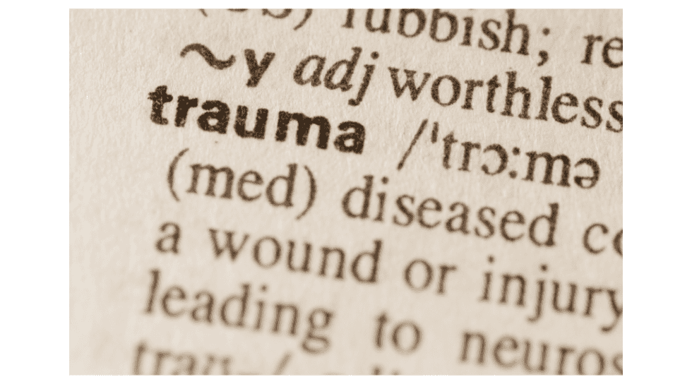 Close-up of the word trauma in a dictionary, related to hypnotherapy for trauma recovery.