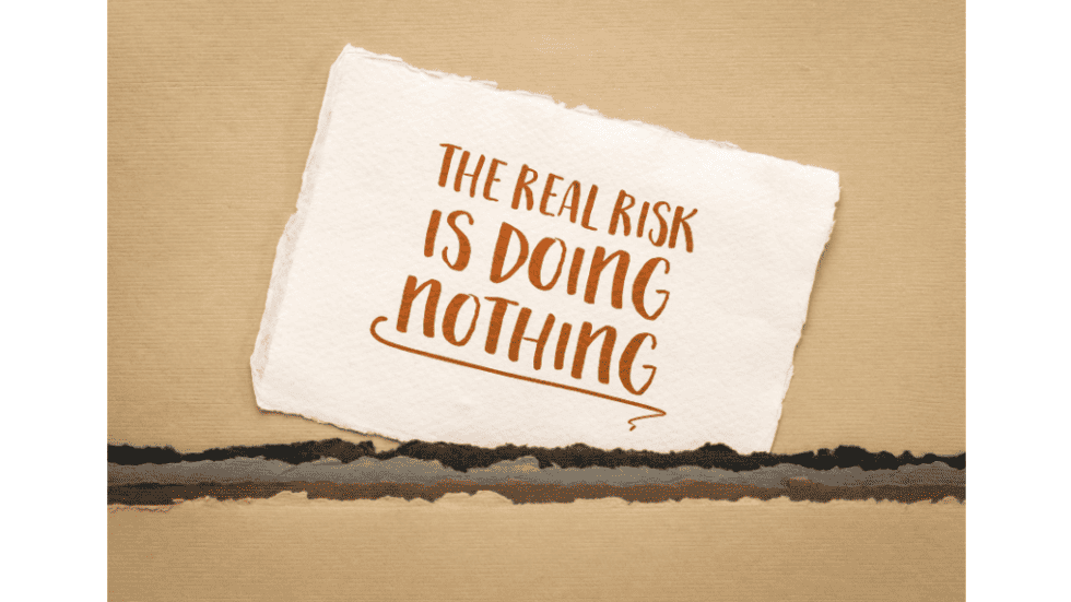 Motivational quote on paper about risk and doing nothing.
