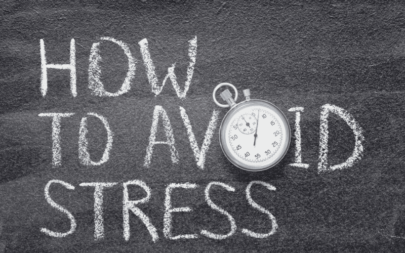 Chalkboard with 'How to Avoid Stress' written and a stopwatch.