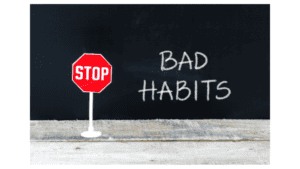 Stop sign and chalkboard with 'Bad Habits' written on it.