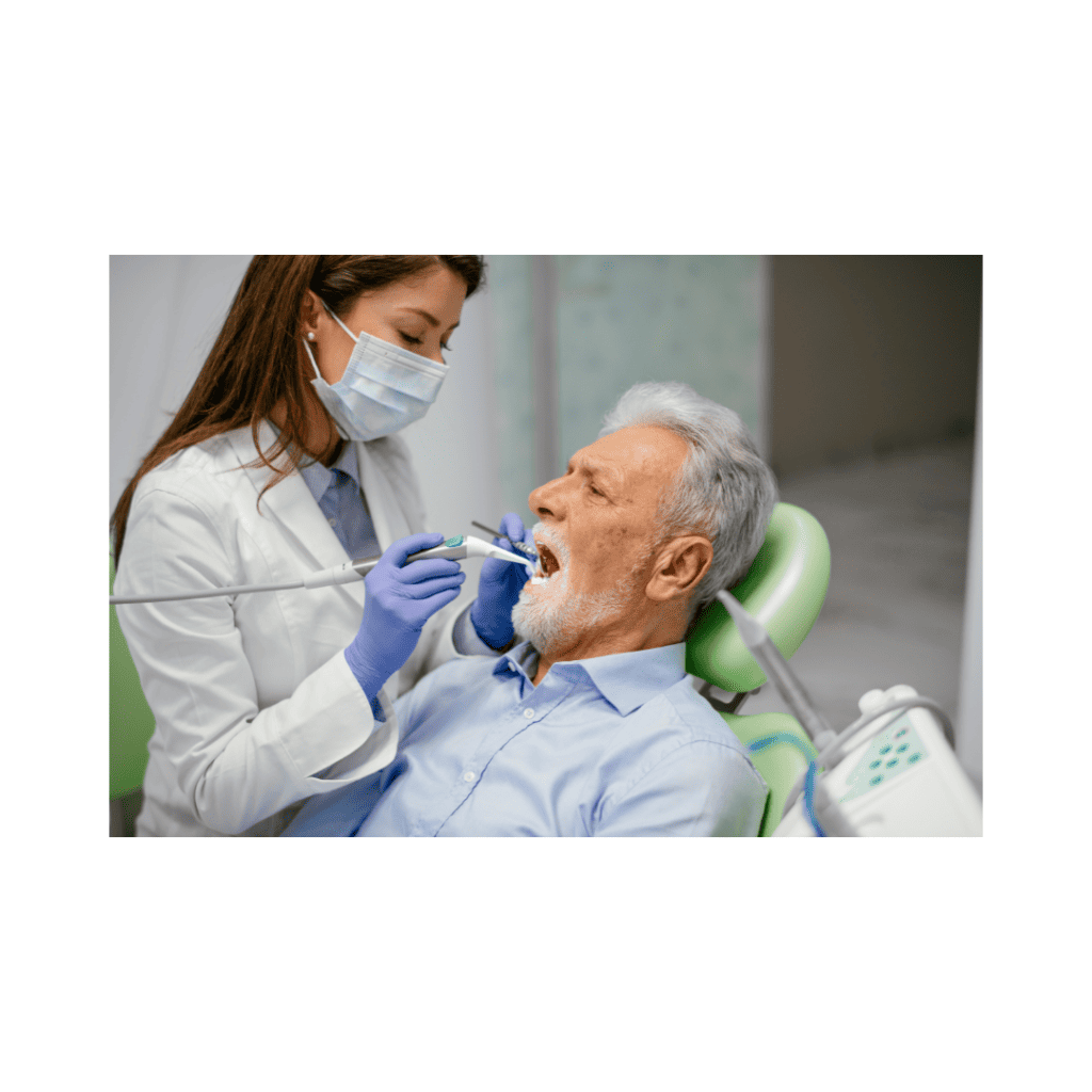 A dentist treating an elderly patient, showcasing how overcoming dental phobia can make procedures stress-free.