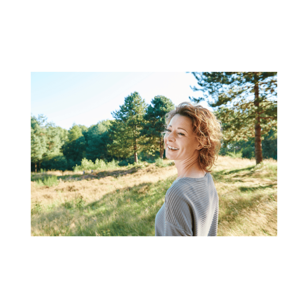 Smiling woman outdoors symbolizing freedom from fear.