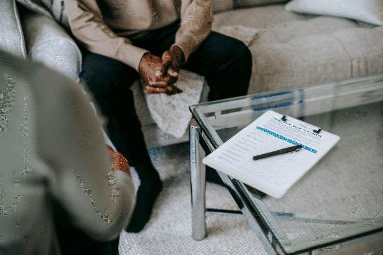 Client discussing treatment plan during a professional hypnotherapy consultation session.