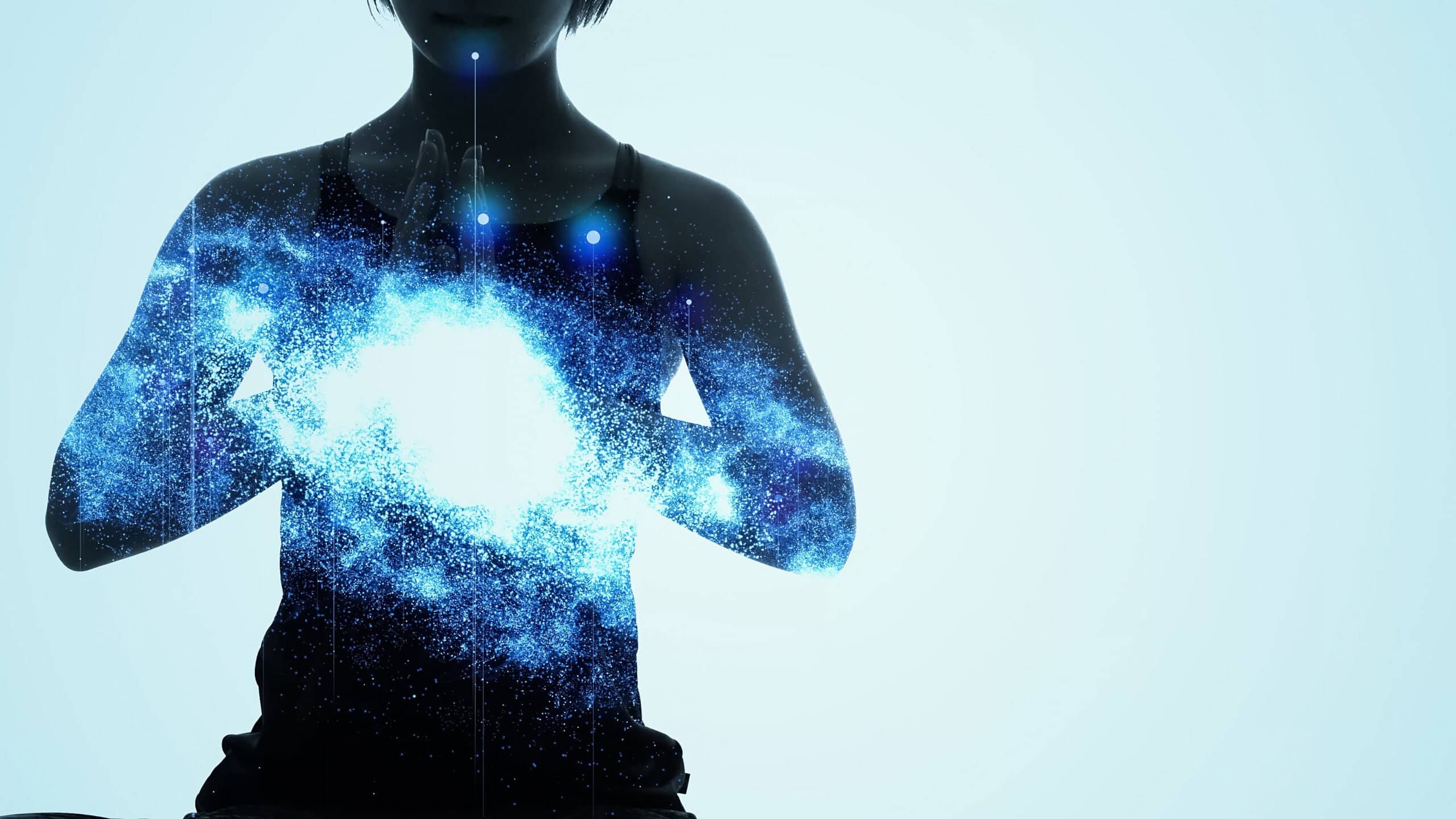 Woman meditating with glowing blue energy around her chest symbolising subconscious healing and self-esteem transformation.