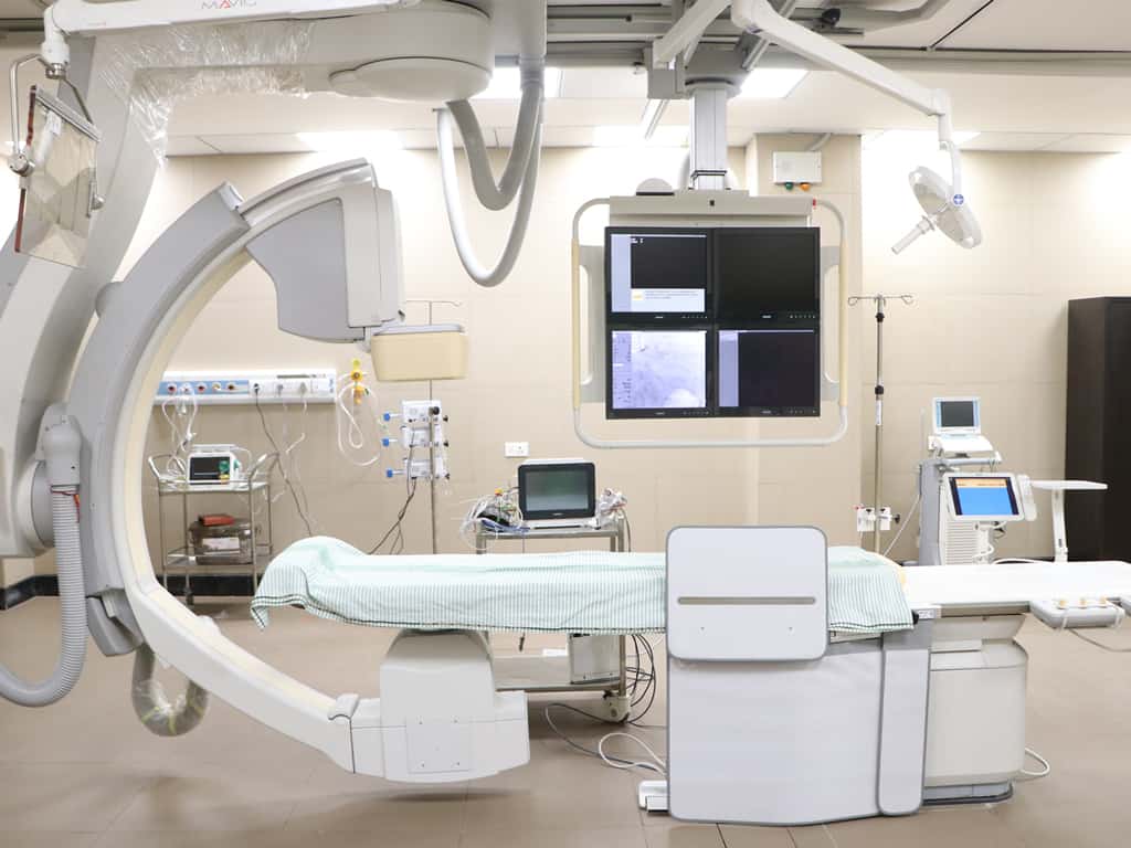 Advanced cardiac catheterization laboratory with imaging equipment and monitoring systems.