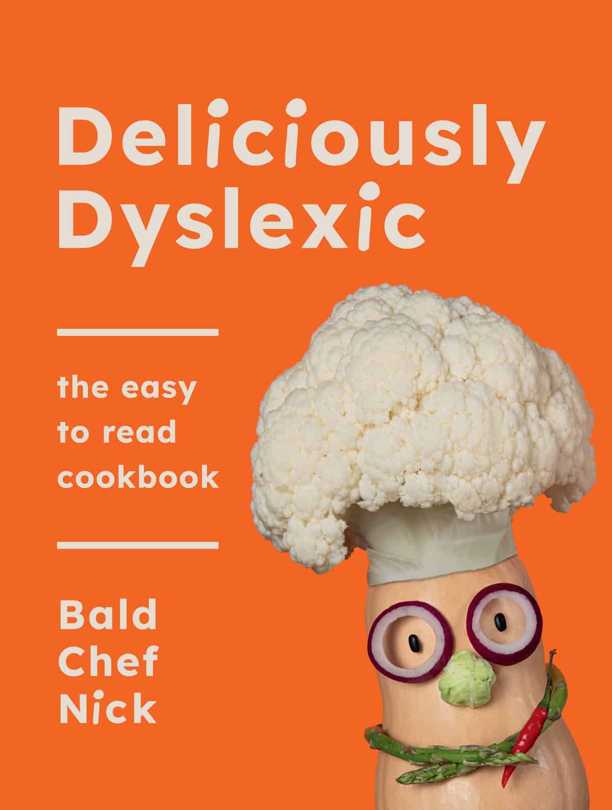 Vegetable chef on orange cookbook cover.