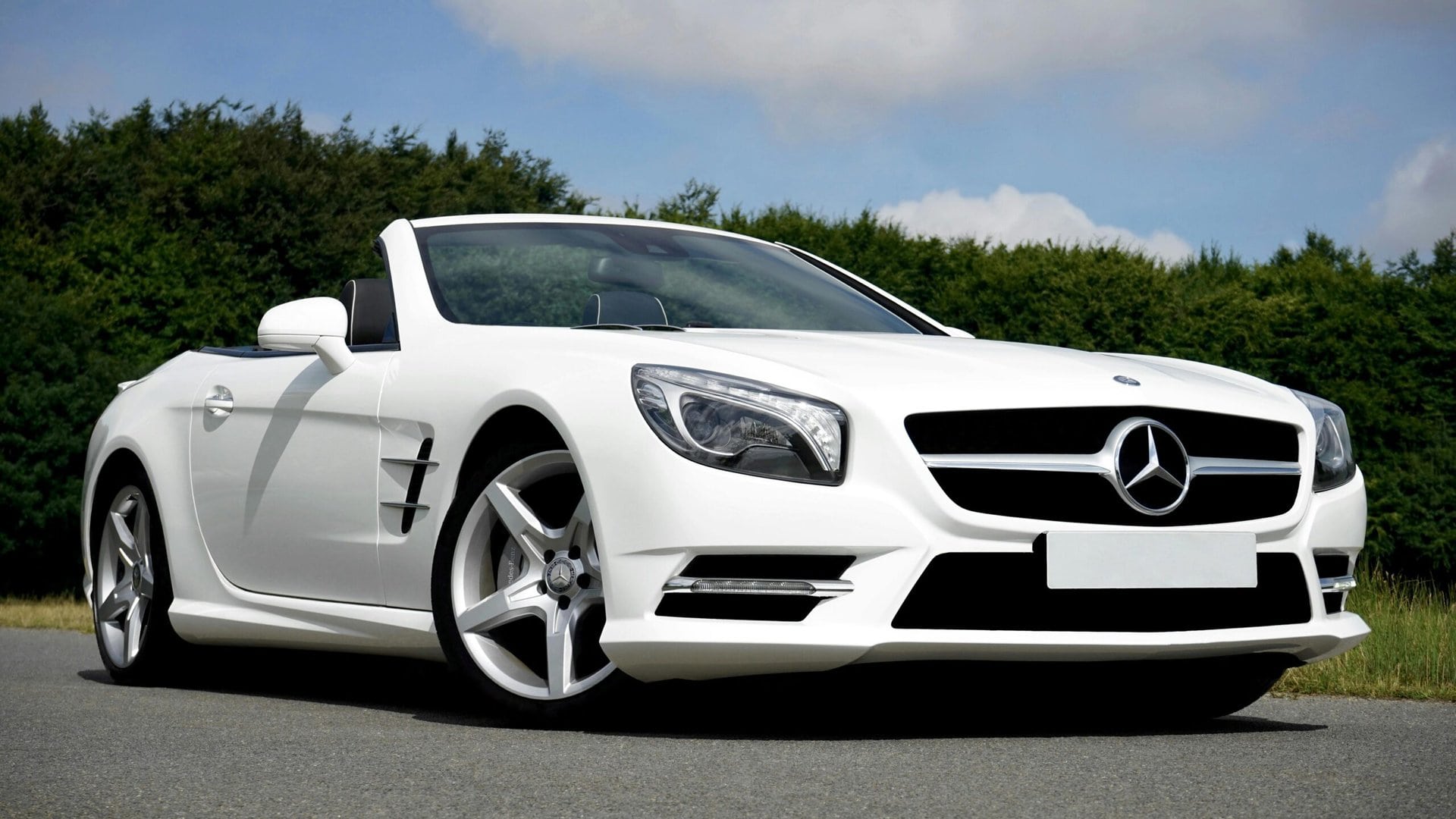 White Mercedes-Benz SLK convertible parked outdoors, showcasing luxury and sporty design, ideal for premium car care services in Del Mar.