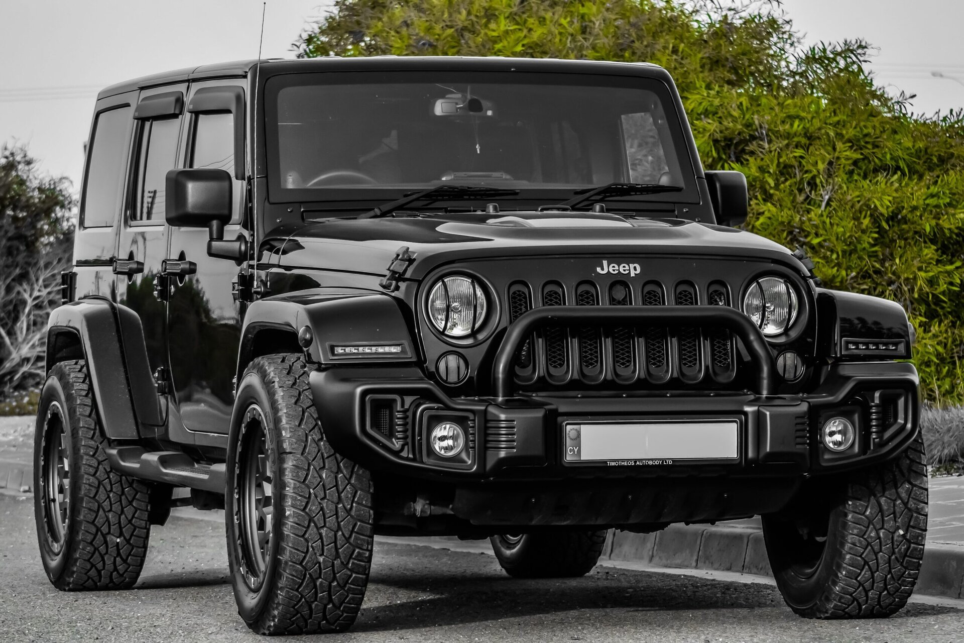 Black Jeep Wrangler parked outdoors, showcasing rugged off-road capabilities and durable design, ideal for adventure and vehicle maintenance at Del Mar Car Care.