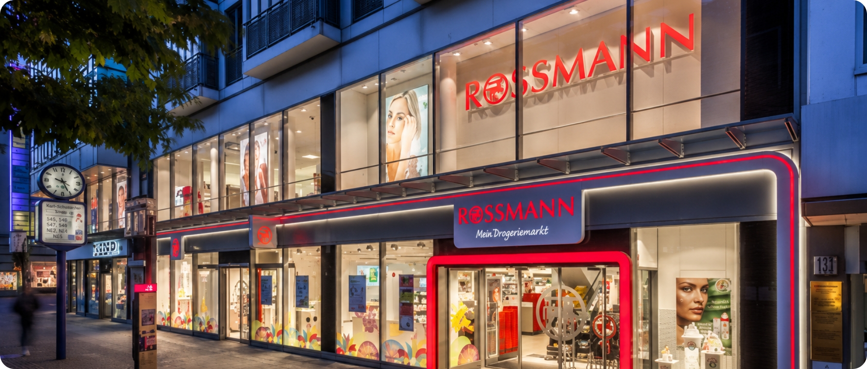 Rossmann retail store with modern facade and large display windows in city center.