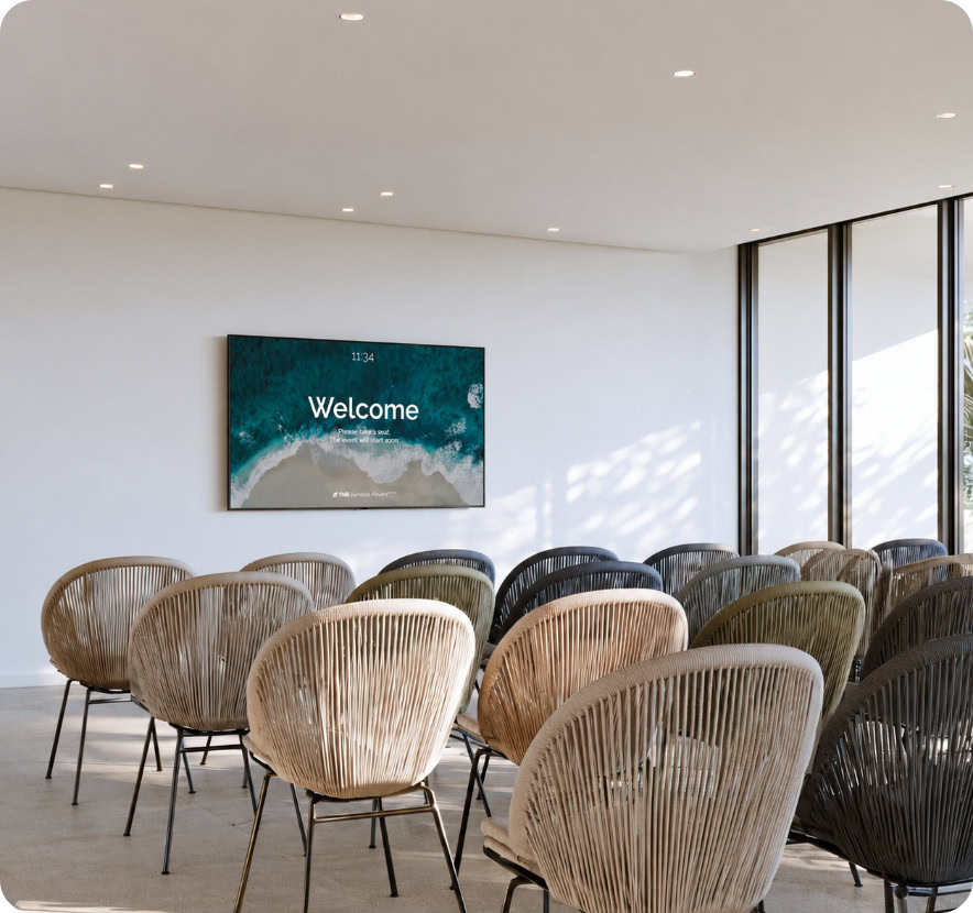 Contemporary conference room with chairs and a welcome screen at Denali Development.