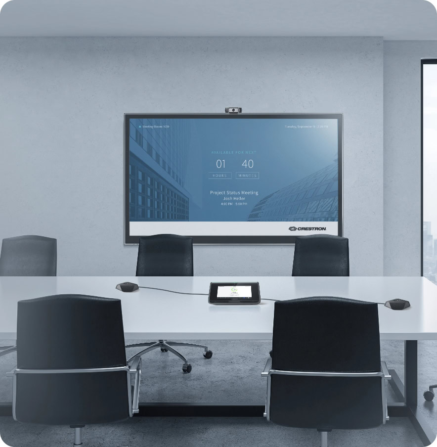 Modern corporate conference room with digital screen and chairs.