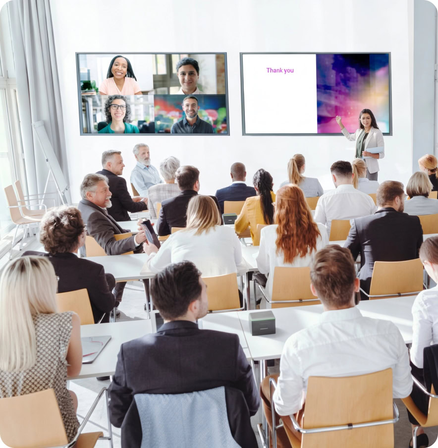 Business professionals attending a corporate presentation in a modern conference room.