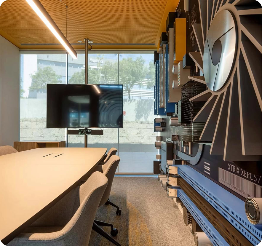 Corporate conference room with large screen and technical equipment.