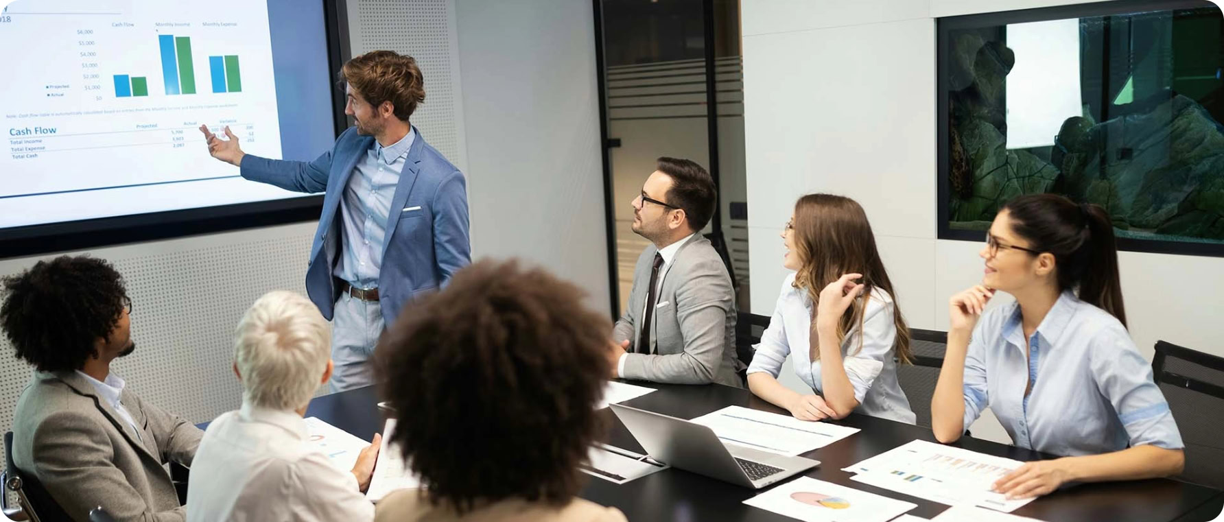 Business team discussing project details in a modern conference room.
