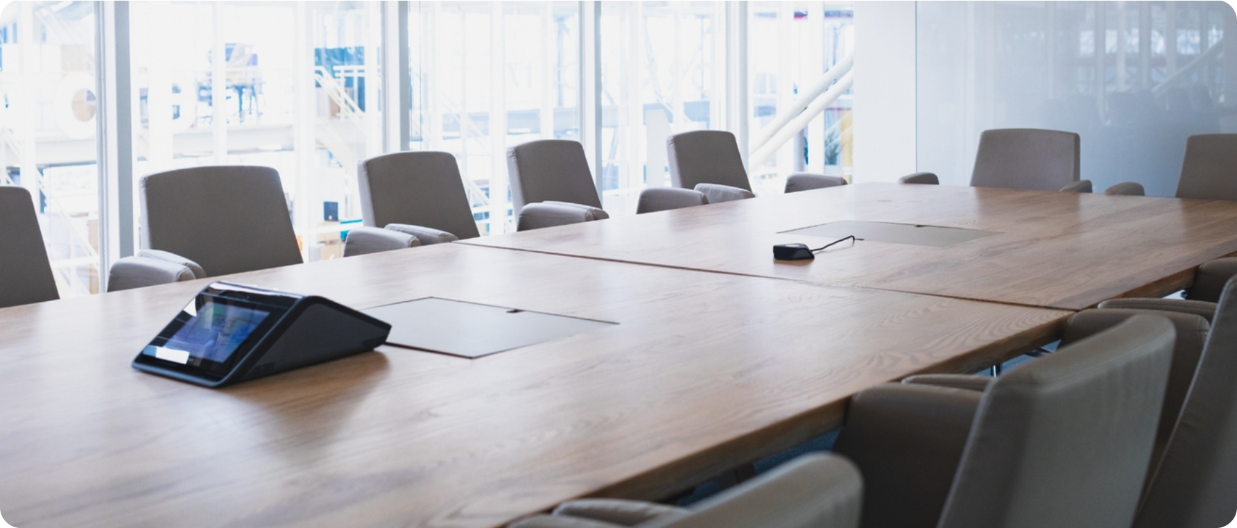 Spacious conference room with a large table and comfortable chairs.