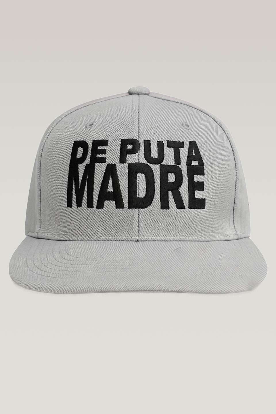 Bold white baseball cap with black "De Puta Madre" logo, made in Italy, streetwear urban style.
