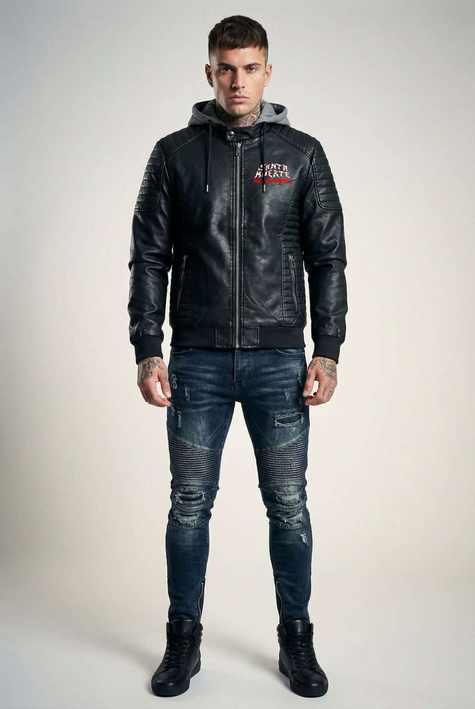 Black leather hoodie jacket with distressed jeans, urban style, and bold graphic design.