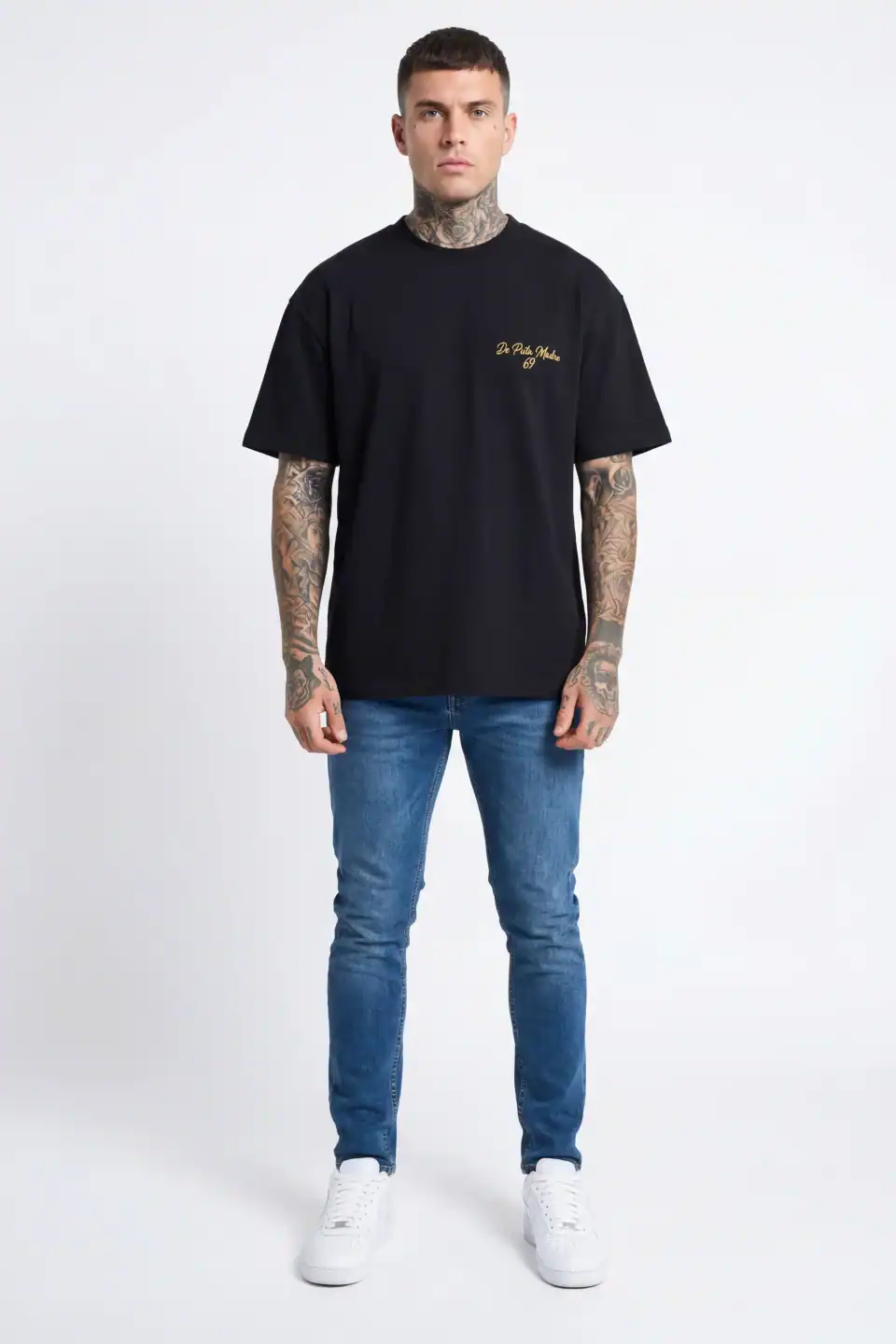 Black T-shirt with gold script logo De Puta Madre 69, made in Italy, streetwear style.