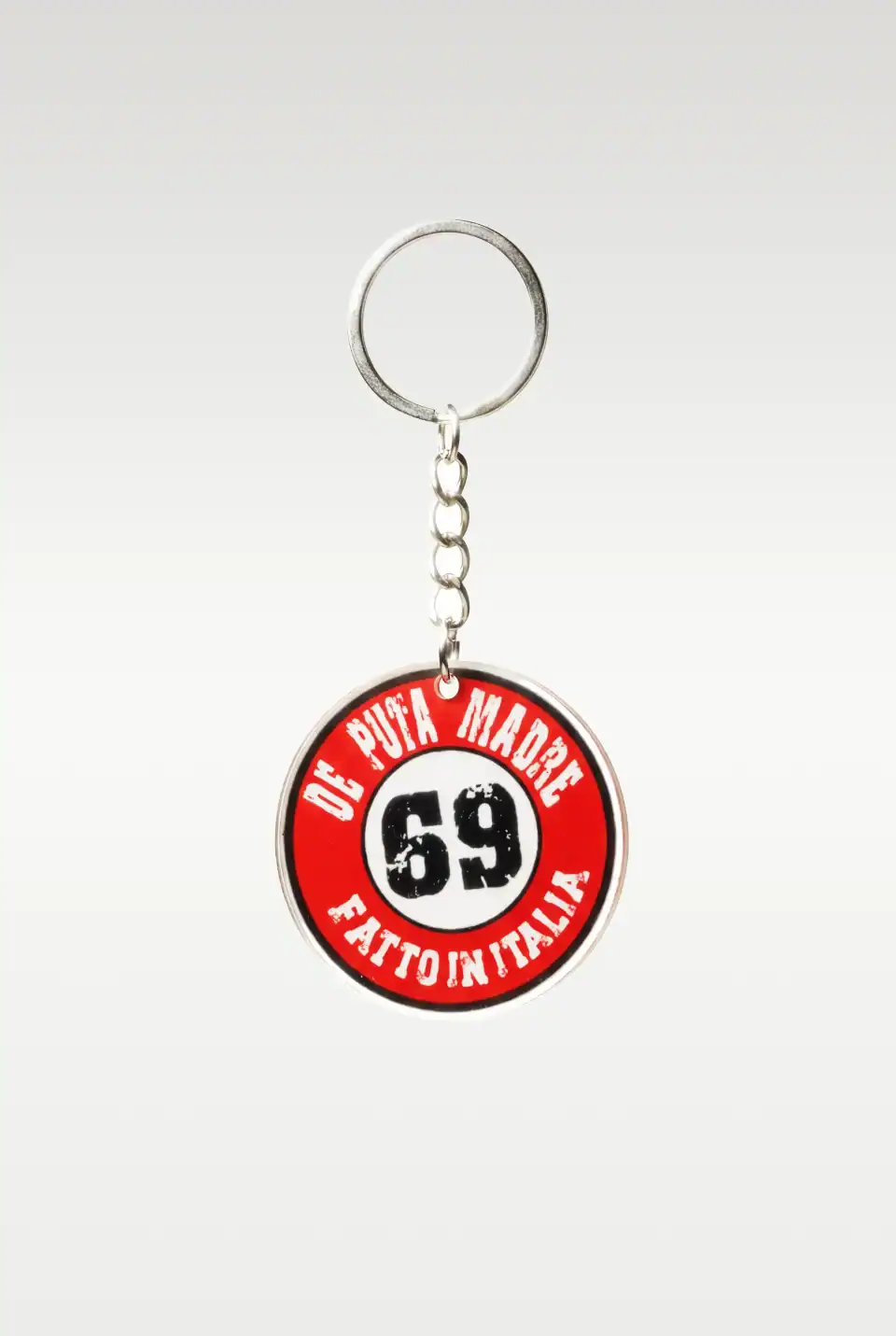 1. Bold Italian streetwear keychain with provocative logo design in red, black, and white.