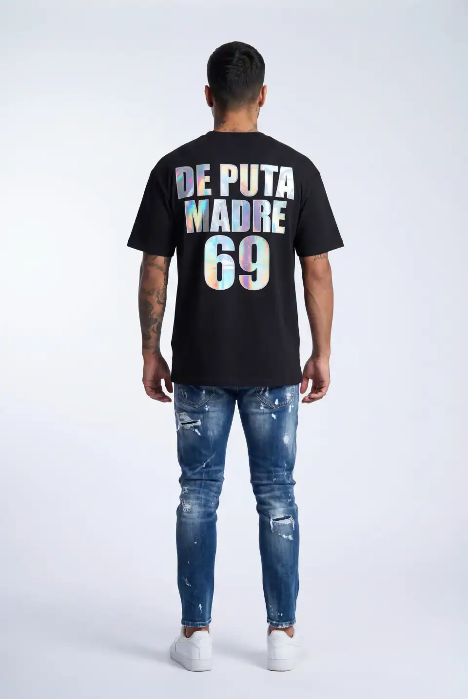 Black T-shirt with bold "De Puta Madre 69" graphic design, styled with distressed jeans and sneakers.