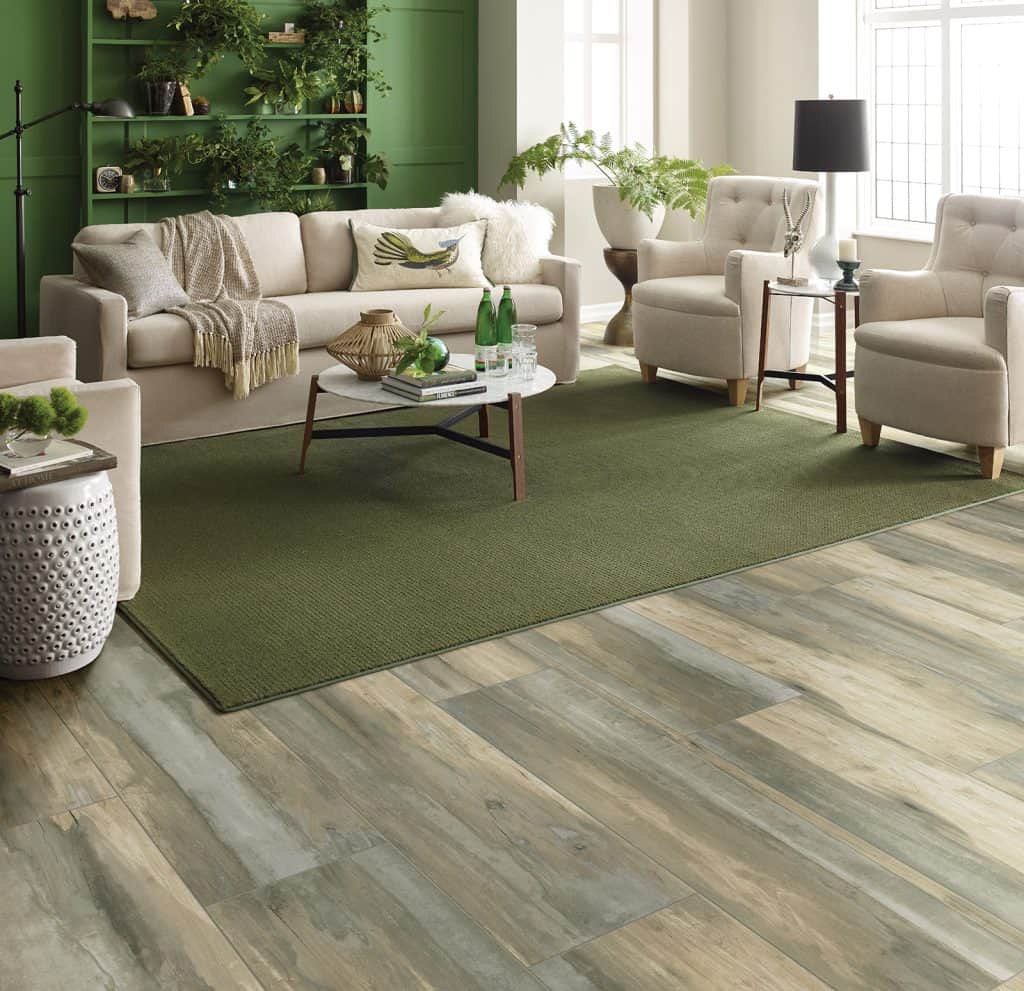 Green rug with couch and chairs.
