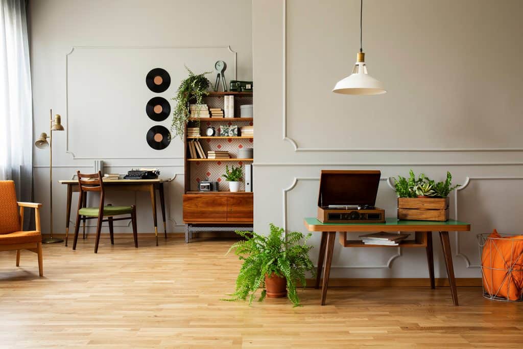 Room with record player, chairs, a desk, and records.