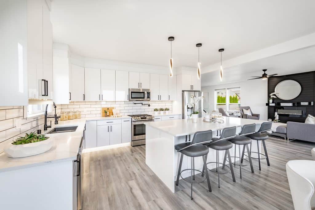 Kitchen with island, stools, counters, and stove.