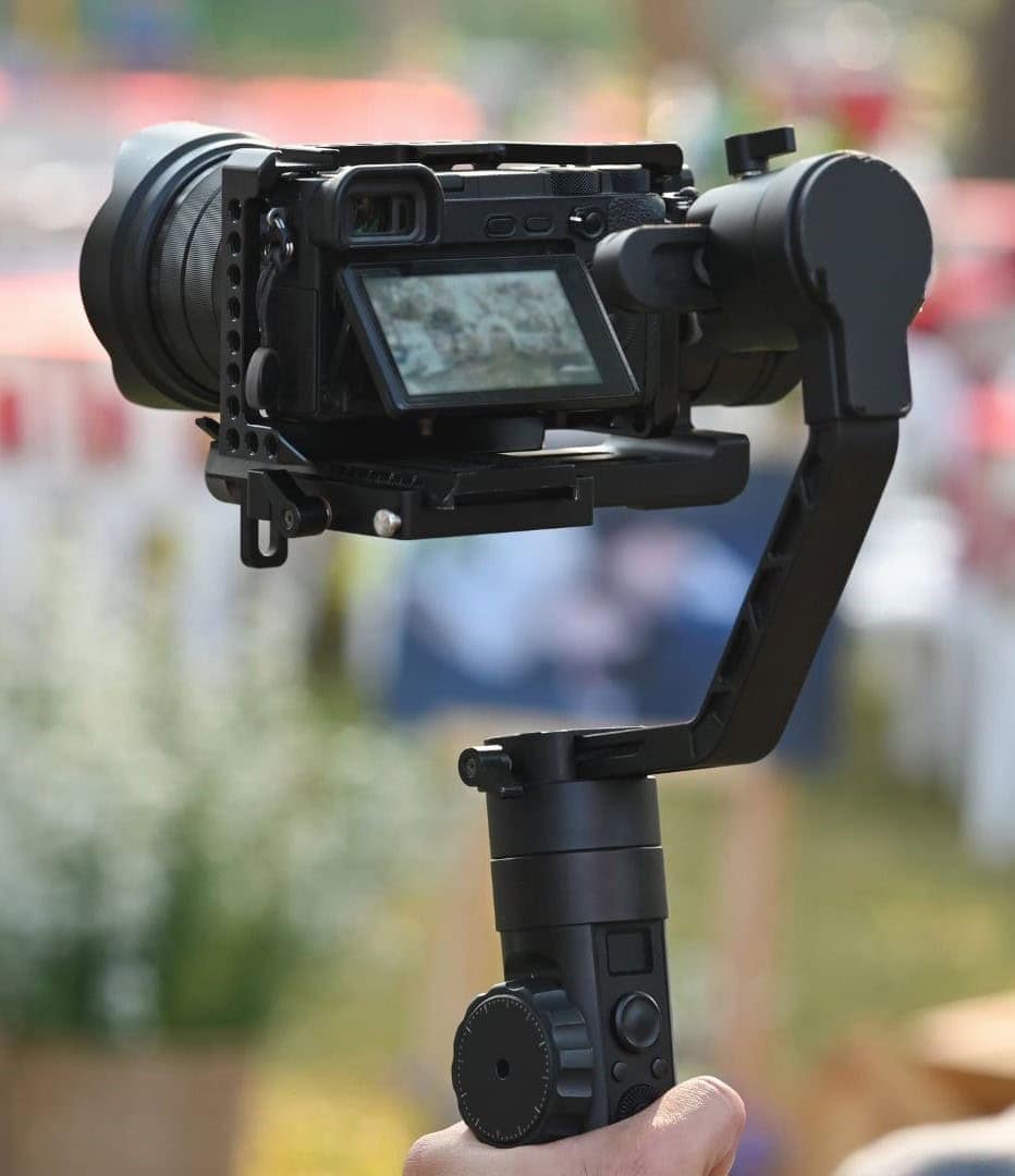 Professional camera on a handheld stabilizer for real estate video production, related to Tenesha Lusk.