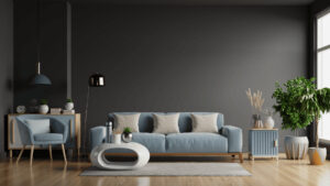 Bright modern living room with grey accent wall, light blue sofa, stylish armchair, contemporary coffee table, and abundant green plants, showcasing a chic home interior design.