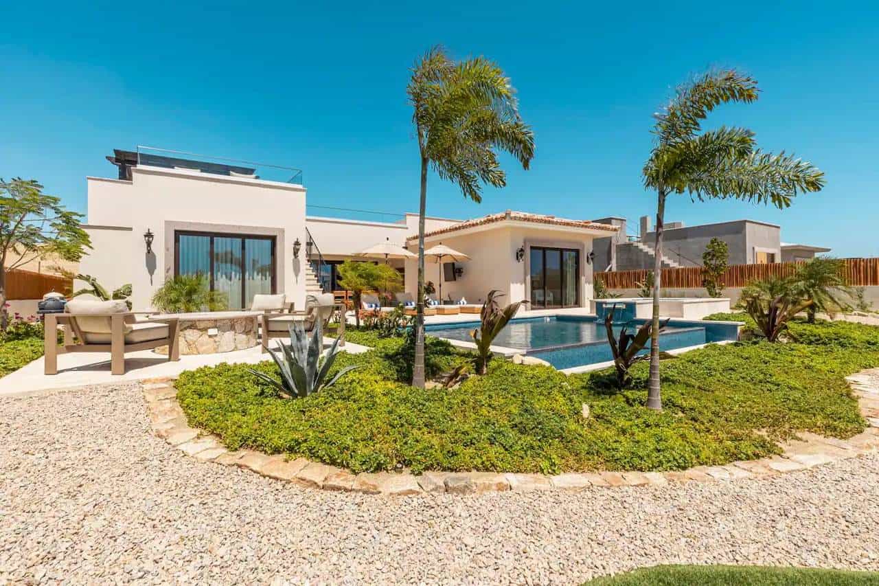 A House With A Pool And Palm Trees