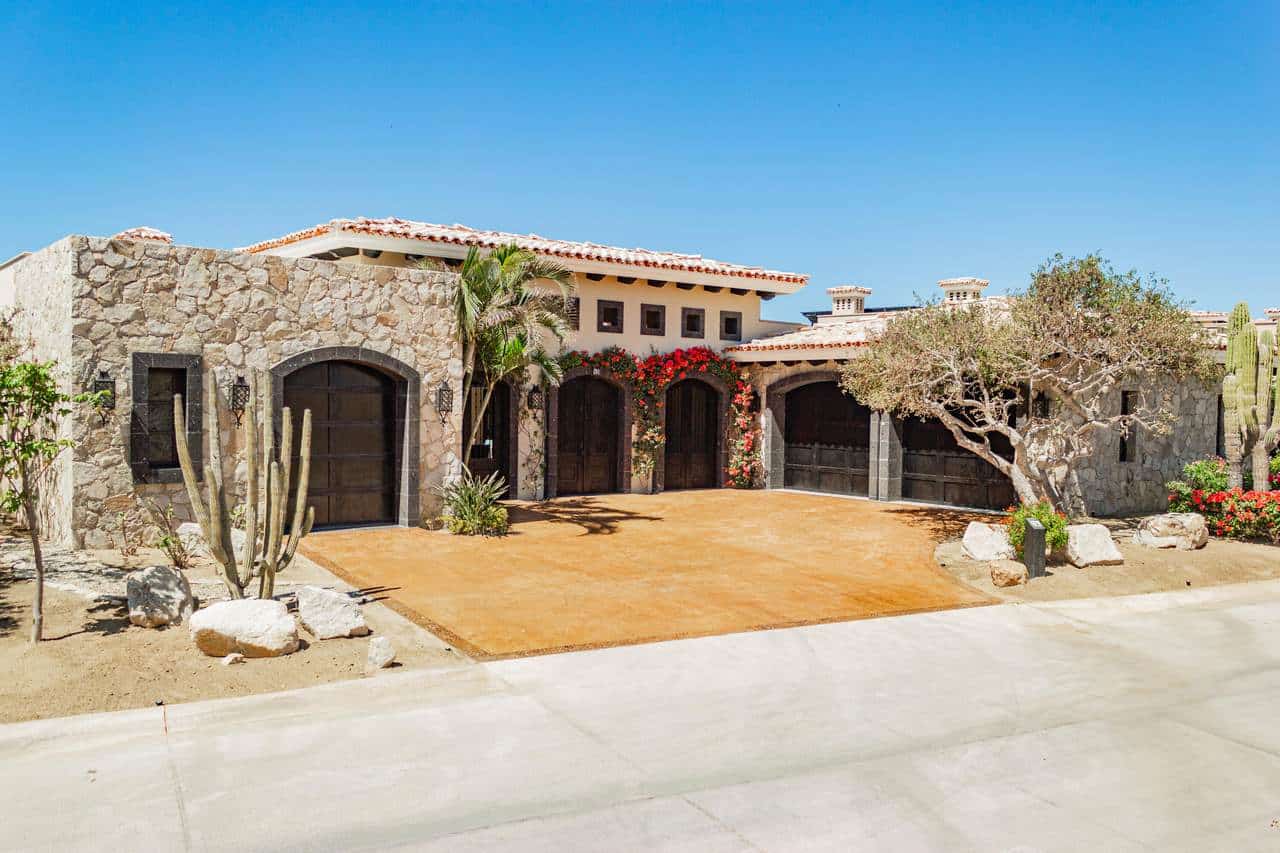 A House With A Stone Wall And A Driveway