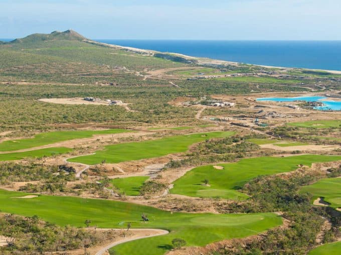 Diama Cabo San Lucas Real Estate Overlooking A Scenic Golf Course Near The Ocean In Baja California, Featuring Lush Green Fairways, Desert Landscape, And Mountain Views.