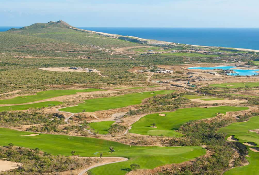 Diama Cabo San Lucas Real Estate Overlooking A Scenic Golf Course Near The Ocean In Baja California, Featuring Lush Green Fairways, Desert Landscape, And Mountain Views.