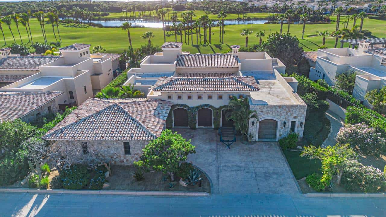 Luxurious Diama Cabo San Lucas Estate With Spanish Tile Roof, Lush Gardens, And A Serene View Of The Nearby Golf Course And Water Features In A Premium Diamante Community.