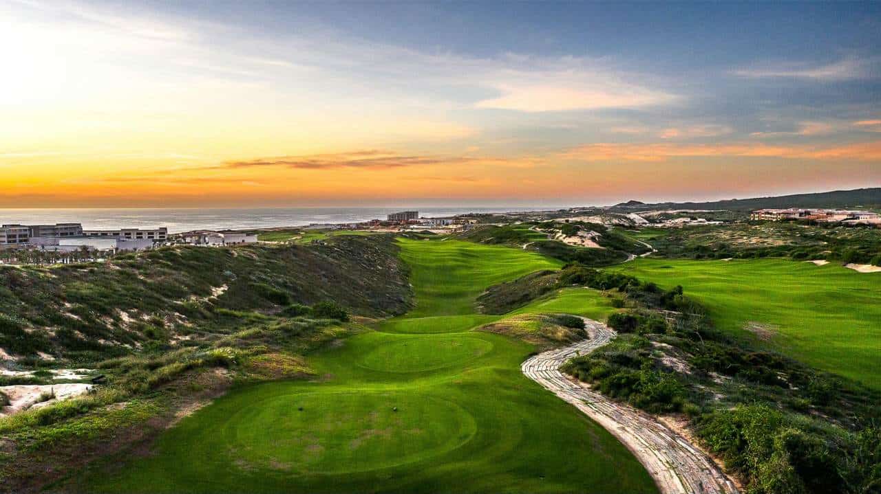 Diamante Cabo San Lucas Golf Course At Sunset With Ocean View And Lush Greens.