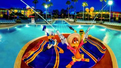 Donald Duck and José Carioca statues cast their lines into the glowing All-Star Music Resort pool, capturing Disney magic at night.