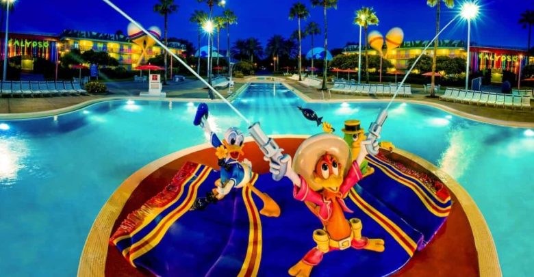 Donald Duck and José Carioca statues cast their lines into the glowing All-Star Music Resort pool, capturing Disney magic at night.